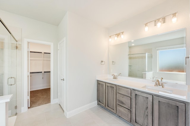 2800 Creekhollow Ct, Denton, TX 76226 - full bathroom with a shower stall, double vanity, a walk in closet, tile patterned flooring, and baseboards