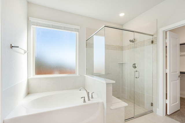 bathroom with tile patterned floors, plus walk in shower, and a healthy amount of sunlight