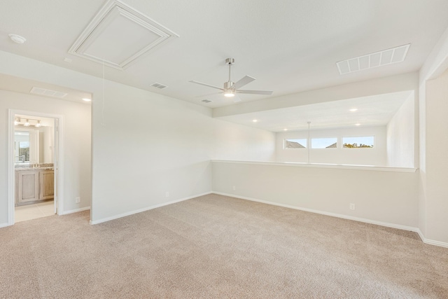 spare room featuring ceiling fan and light carpet