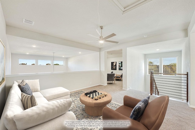 carpeted living room featuring a textured ceiling and ceiling fan