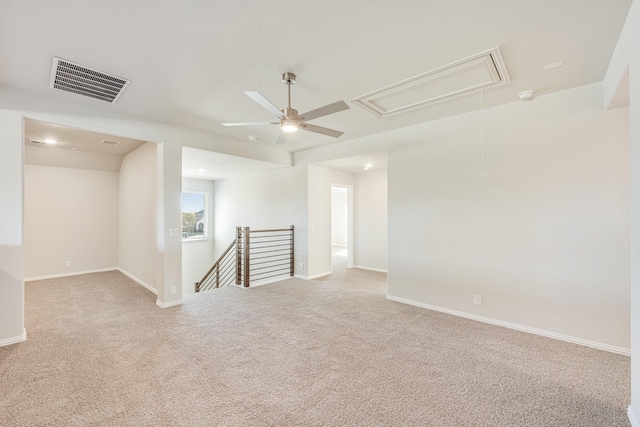 carpeted spare room featuring ceiling fan