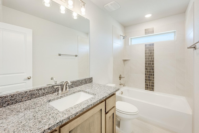 full bathroom with vanity, toilet, and tiled shower / bath