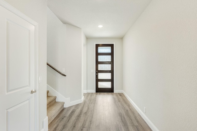 2800 Creekhollow Ct, Denton, TX 76226 - entryway with light wood-style floors, baseboards, and stairs
