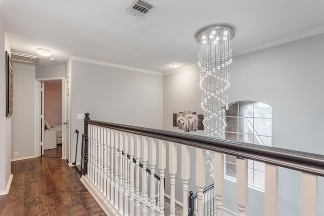 hallway featuring hardwood / wood-style floors, a chandelier, and ornamental molding