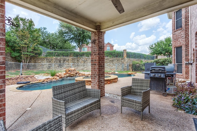 view of patio with a swimming pool with hot tub and grilling area