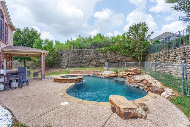 view of swimming pool featuring an in ground hot tub and a patio