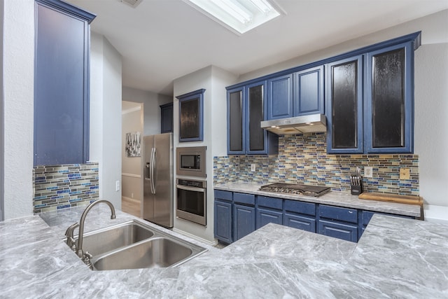 kitchen featuring decorative backsplash, appliances with stainless steel finishes, and sink