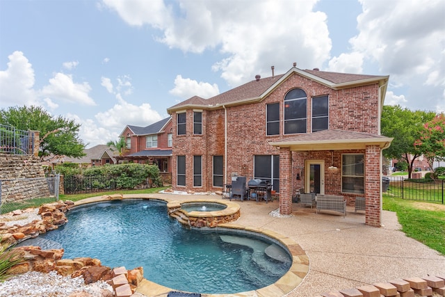 view of swimming pool with an in ground hot tub and a patio