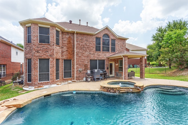 view of pool with an in ground hot tub and a patio