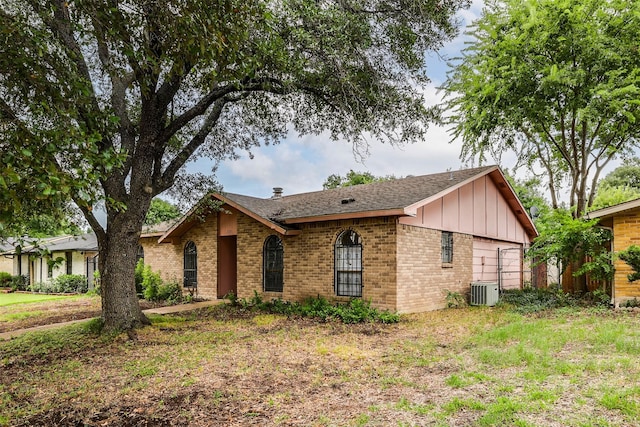 ranch-style house featuring a front yard and central air condition unit