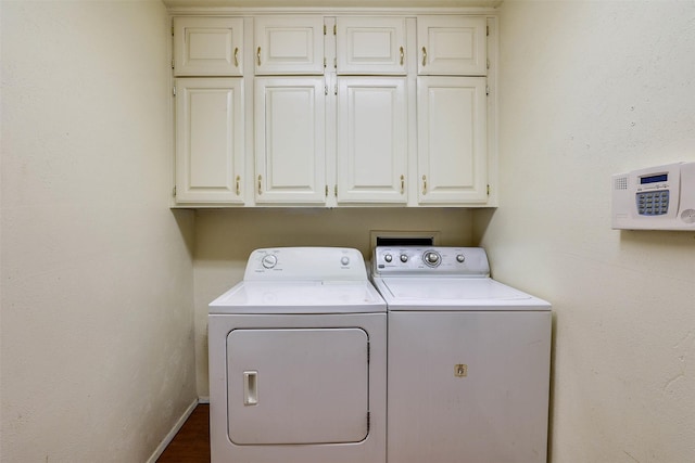 laundry area with cabinets and washer and clothes dryer