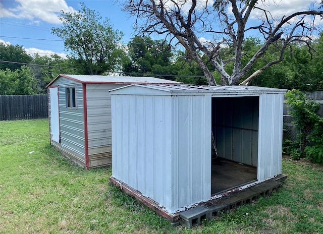 view of shed featuring fence