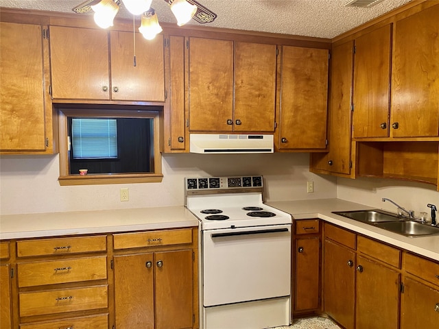 kitchen featuring sink, electric stove, and a textured ceiling