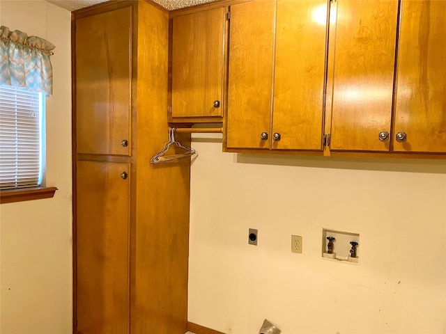 washroom featuring hookup for a washing machine, hookup for an electric dryer, and cabinets