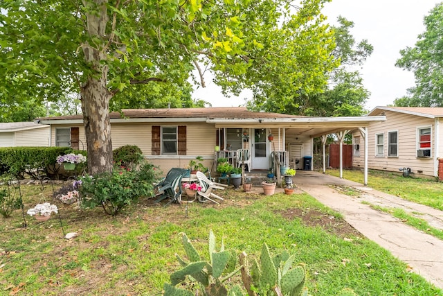 ranch-style house featuring cooling unit, a front lawn, and a carport