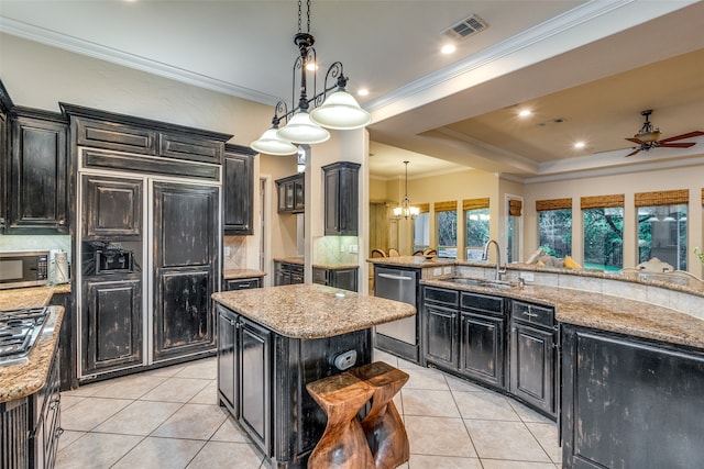 kitchen with a kitchen island, decorative backsplash, hanging light fixtures, and stainless steel appliances