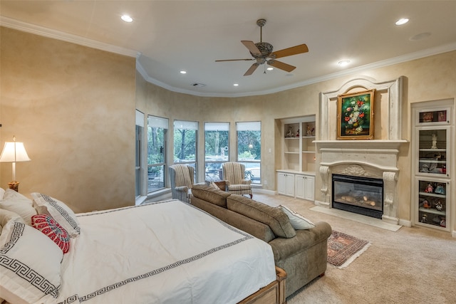 carpeted bedroom featuring ceiling fan, crown molding, and a high end fireplace