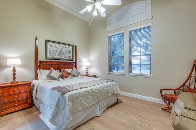 bedroom with ornamental molding, ceiling fan, and light wood-type flooring