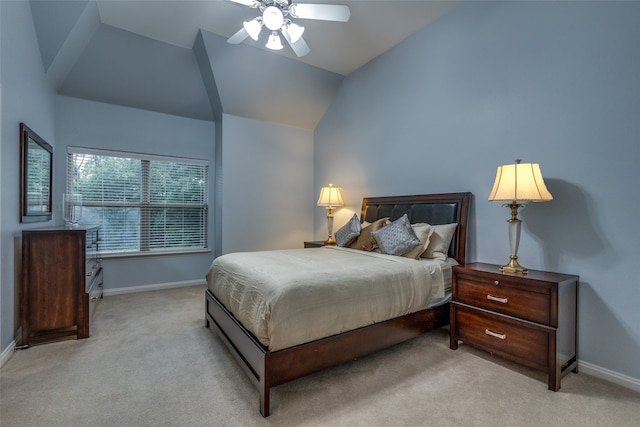 bedroom featuring vaulted ceiling, light colored carpet, and ceiling fan