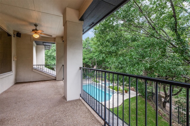 balcony featuring ceiling fan and a fenced in pool