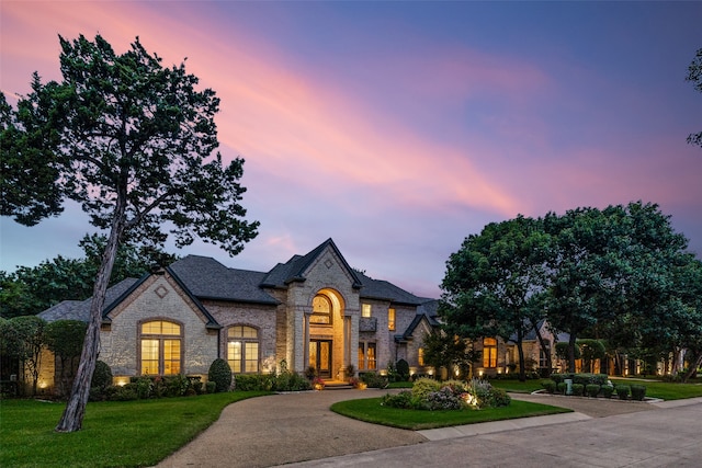 french country home with a yard