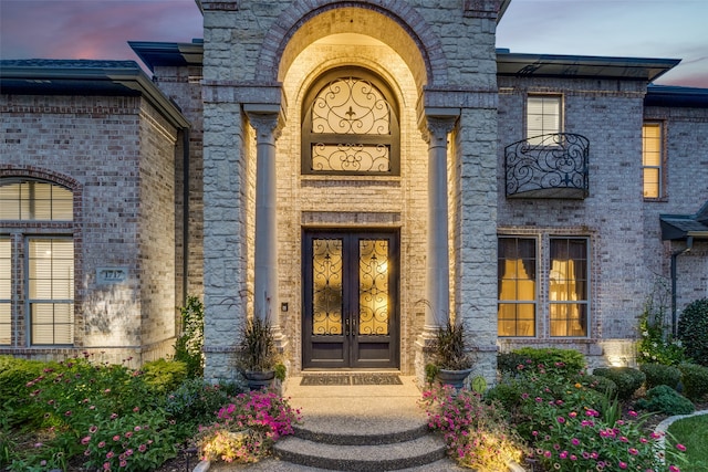 exterior entry at dusk with french doors