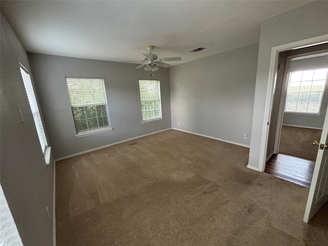 spare room featuring ceiling fan and carpet floors