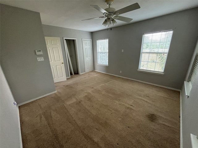 carpeted empty room with ceiling fan