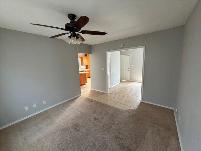 carpeted empty room featuring ceiling fan