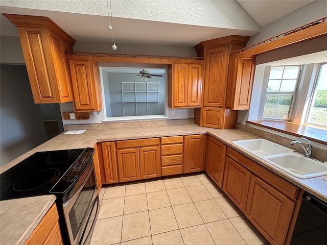 kitchen with light tile patterned floors, vaulted ceiling, sink, black appliances, and ceiling fan