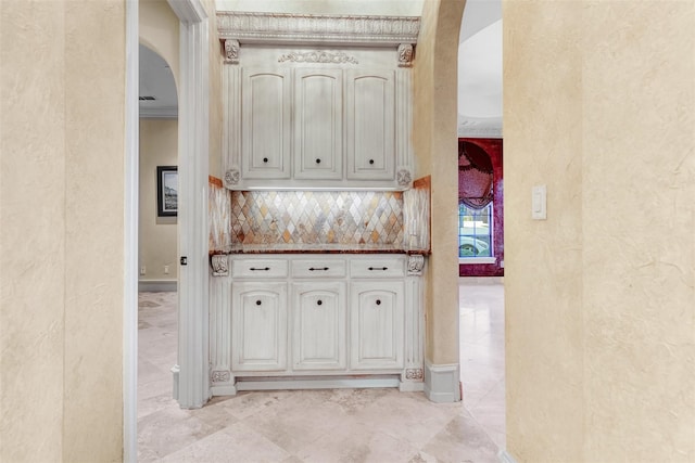 interior space with white cabinets, tasteful backsplash, and light tile patterned floors