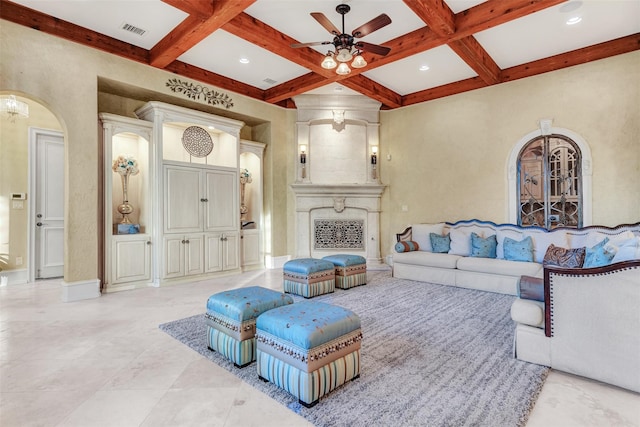 living room featuring light tile patterned flooring, a fireplace, ceiling fan, beamed ceiling, and coffered ceiling