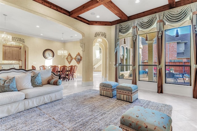 living room featuring light tile patterned floors, crown molding, beam ceiling, a notable chandelier, and coffered ceiling