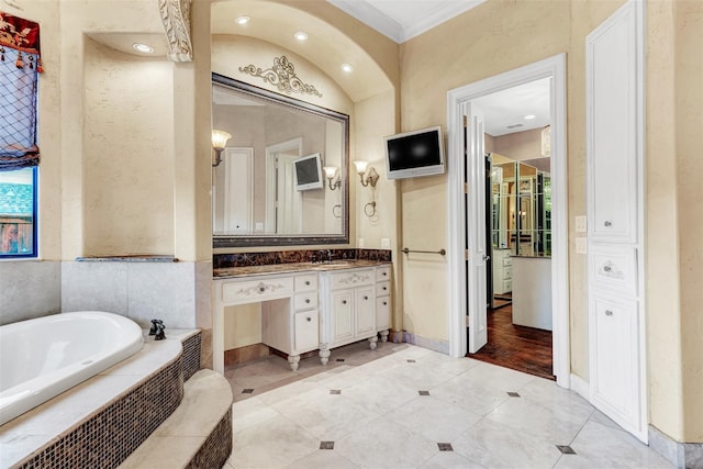 bathroom featuring vanity, wood-type flooring, crown molding, and a relaxing tiled tub