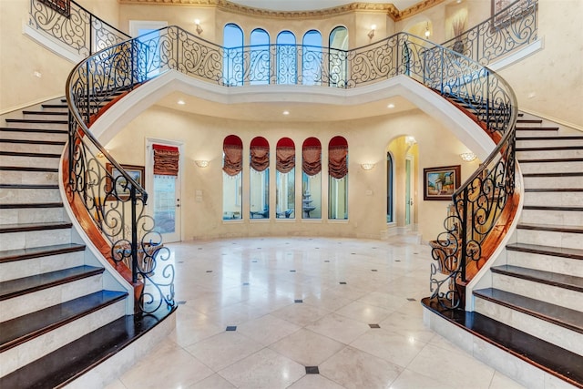 tiled entryway with a towering ceiling