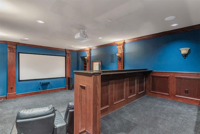 cinema room featuring bar, crown molding, and carpet flooring