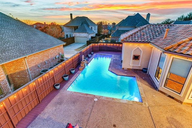 pool at dusk with a patio