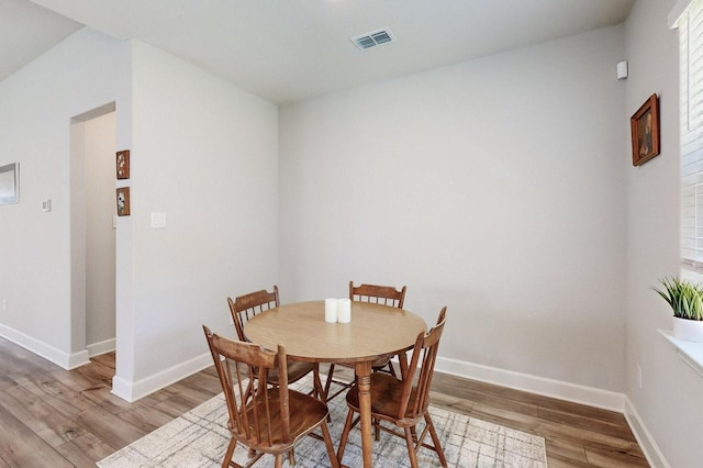 dining area with hardwood / wood-style floors