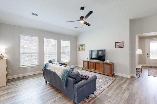 living room featuring ceiling fan, lofted ceiling, and light hardwood / wood-style flooring