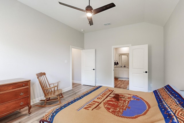 bedroom with ceiling fan, lofted ceiling, light hardwood / wood-style floors, and ensuite bath