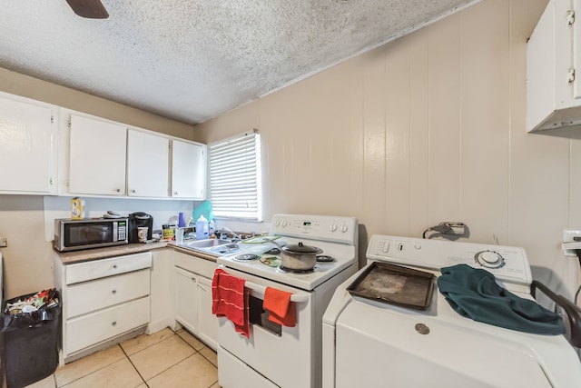 kitchen with white electric range oven, white cabinets, washer / dryer, a textured ceiling, and light tile patterned floors