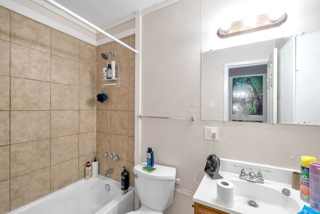 full bathroom with toilet, vanity, and tiled shower / bath