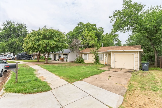 ranch-style house featuring a garage and a front lawn