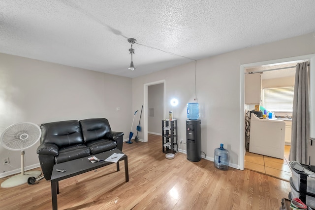 sitting room featuring a textured ceiling and light hardwood / wood-style flooring