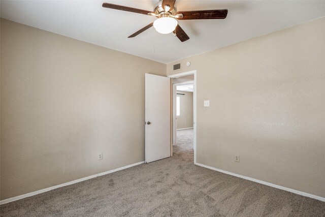 carpeted empty room featuring ceiling fan