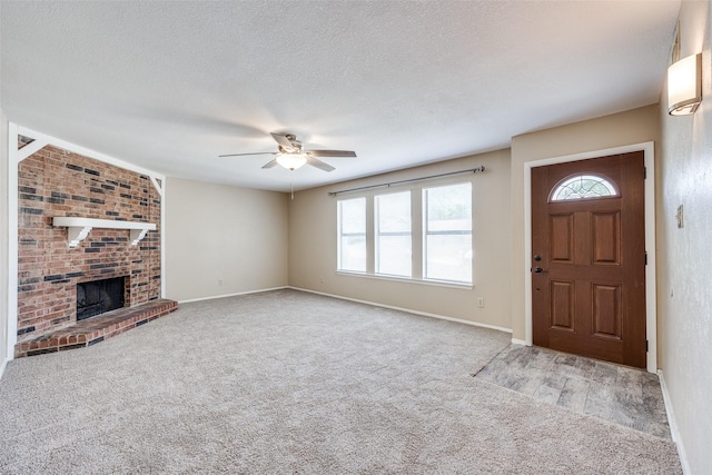 unfurnished living room with a wealth of natural light, light colored carpet, and a fireplace