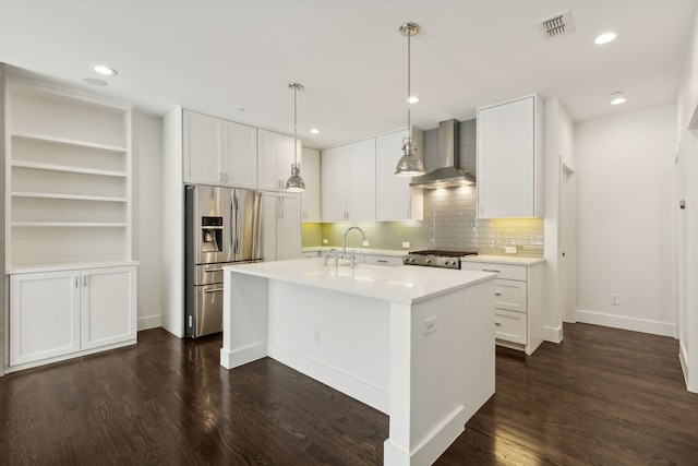 kitchen with white cabinets, a center island with sink, backsplash, dark hardwood / wood-style floors, and wall chimney exhaust hood