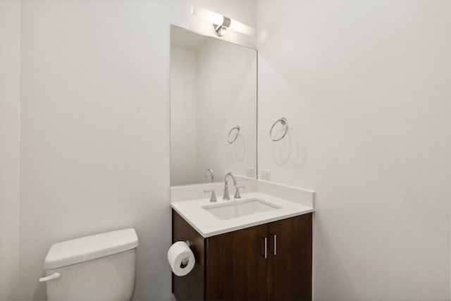 bathroom featuring toilet and vanity