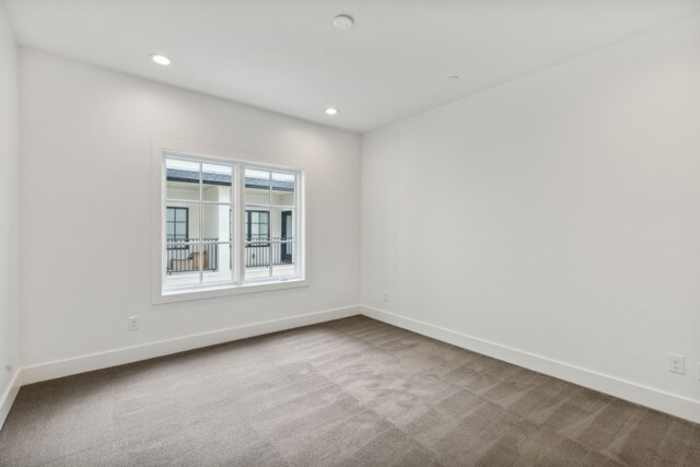 carpeted empty room with recessed lighting and baseboards