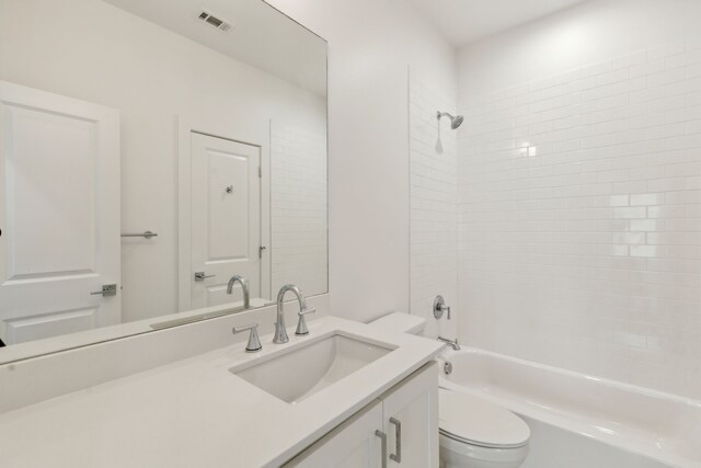 bathroom with vanity, toilet, washtub / shower combination, and visible vents